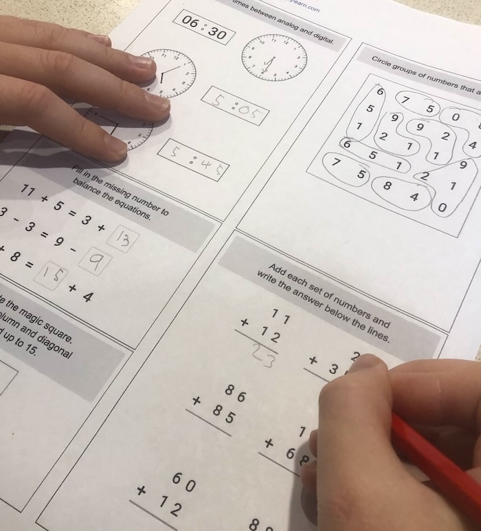 Child completing a printed worksheet